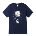 Astronaut holding a moon-shaped balloon T-shirt with space and stars design, perfect for children interested in space and science.