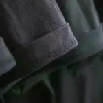 Close-up of a dark fabric sleeve with detailed stitching.