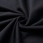 Close-up of smooth black fabric twisted into a spiral, ideal for science-themed decor or educational toy displays. The fabric's texture and deep color highlight its versatility in science-related proj.