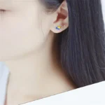 Colorful planet Earth earring with blue, yellow, and white details.