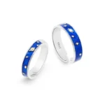 Pair of silver rings with blue enamel featuring celestial designs including stars, moons, and planets, perfect for astronomy enthusiasts and as unique jewelry accessories.