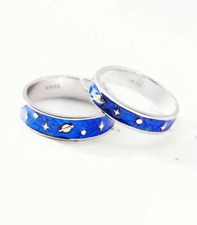 Silver rings with space-themed blue enamel design featuring planets, stars, and moons, perfect for science and astronomy enthusiasts.
