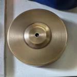 Metal disc with central hole for science experiments or educational demonstrations.