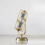 Elegant sand timer with a gold frame and glass body, perfect for educational and decorative purposes.