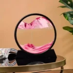 Decorative glass sculpture with pink and white swirling patterns inside a circular frame.