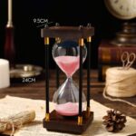 Elegant hourglass timer with pink sand, measuring 24cm in height and 9.5cm in width, ideal for science decor and educational demonstrations.