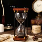 A classic hourglass timer with black sand, perfect for educational demonstrations or decorative purposes.