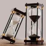 Elegant black and white sand hourglasses with modern design, perfect for home decor or educational purposes.