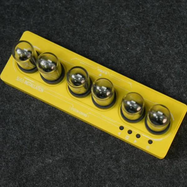Portable science experiment kit with six metallic spheres on a yellow base.