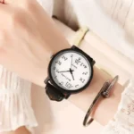 Modern wristwatch displaying time and date, paired with a metallic bracelet on a person's wrist, showcasing stylish accessories for science enthusiasts.