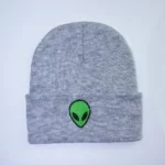 Gray beanie with a small embroidered green alien head logo, perfect for science lovers and space fans.
