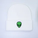 Alien head embroidered beanie hat with a green alien face design on a white background, perfect for science lovers and space enthusiasts.