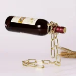 Artistic wine bottle sculpture with gold chain and rope, creating a unique decorative piece for science and art enthusiasts.