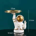 A whimsical astronaut-themed balance scale with a gold tray, designed for science decor and educational purposes. Perfect for science enthusiasts and kids' learning spaces.