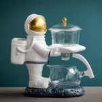 Astronaut-themed science gadget with a transparent container and gold accents, designed for educational and decorative purposes.