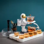 A playful space-themed tea set for children, featuring an astronaut figure pouring tea into small cups, perfect for educational and imaginative play.