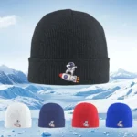 Black knit beanie hat featuring a cute astronaut and rocket patch, perfect for winter wear and space-themed outfits.