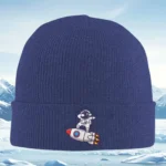 Cozy navy blue knit beanie featuring a cute astronaut riding a rocket patch, perfect for winter adventures and space enthusiasts.