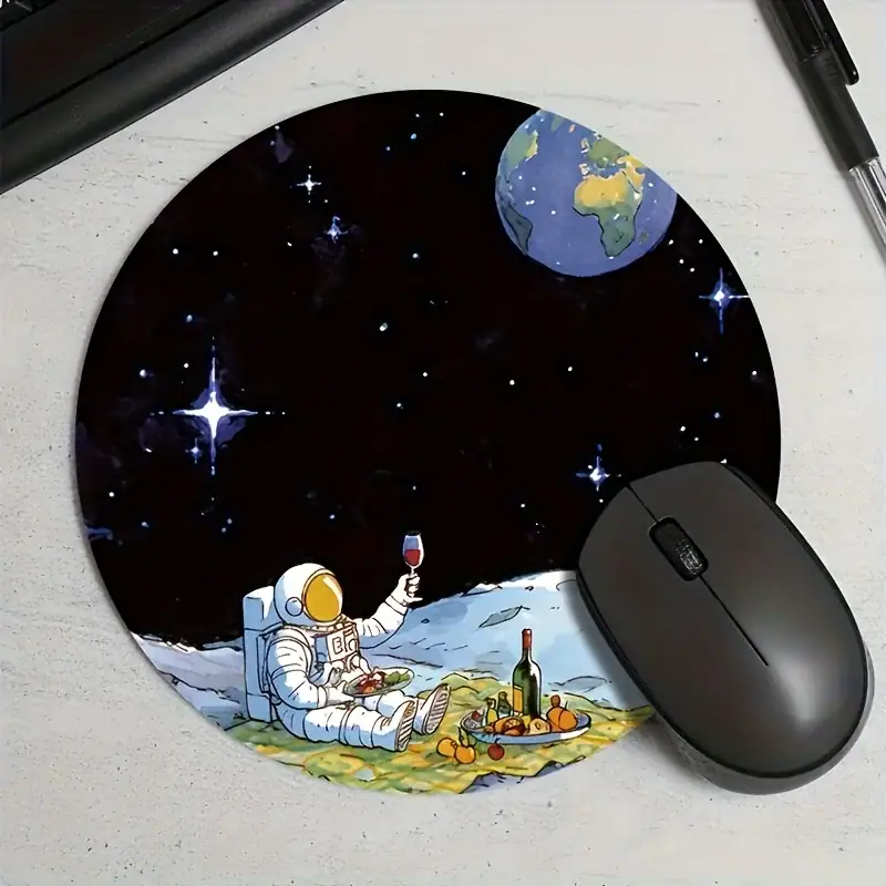 Astronaut enjoying space-themed picnic mouse pad Space-themed astronaut mouse pad with Earth and stars design.