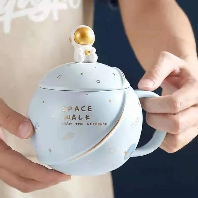 Space Mug - Talk to the Universe A ceramic mug designed with space-themed decorations, featuring a small astronaut figure on top and the words "Space Walk" on the side, perfect for science and space enthusiasts.