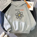 Gray hoodie featuring a colorful atomic model graphic and the text "Quantum Physics" in bold letters, perfect for science enthusiasts and students.