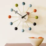 Stylish wall clock featuring colorful spherical markers and minimalist design, perfect for contemporary home decor and adding a playful touch to any room.