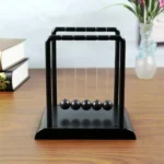 Newton's Cradle desktop toy demonstrating conservation of momentum and energy. Perfect for science enthusiasts and educational settings.