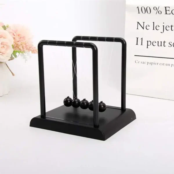 Newton's Cradle desktop toy demonstrating conservation of momentum and energy.