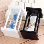 Elegant sand timers with black and white frames, perfect for educational and decorative purposes, showcasing classic hourglass design.
