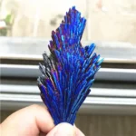 A striking blue crystal mineral specimen with elongated, shimmering crystals radiating outward. Perfect for science decor and educational displays.
