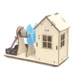 Small wooden house model with wind turbine fan and electric motor, educational science gadget for demonstrating renewable energy principles.