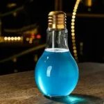 A light bulb-shaped container filled with vibrant blue liquid, used for science demonstrations and educational purposes.