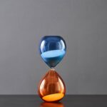 Blue and orange hourglass timer on a gray background.