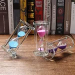 Hourglass timers with colorful sand in clear glass containers, perfect for science experiments and educational decor.