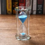 Hourglass with blue sand for science experiments and decor.