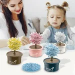 Kids and adult enjoying colorful crystal trees in pots, educational science toy for children to learn about crystal growth and science experiments.