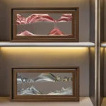 Framed mountain landscape artwork featuring pink and gray mountain ranges, displayed on a modern shelf.
