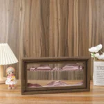 Decorative wooden mountain landscape display case with glass front, showcasing layered mountain peaks in pink and purple hues, ideal for home decor or educational displays.