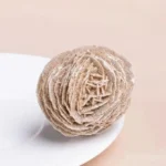 Close-up of a textured, fuzzy ball model used for science demonstrations and educational purposes.