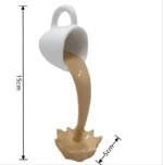White ceramic coffee mug toy pouring a brown liquid into a splash-shaped container, measuring 15cm in height and 5cm in width, designed for educational and decorative purposes.