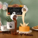 Decorative coffee mug fountains with flowing coffee effect, perfect for coffee lovers and as a fun kitchen or office decor piece.