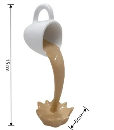White ceramic coffee mug toy pouring a brown liquid into a splash-shaped container, measuring 15cm in height and 5cm in width, designed for educational and decorative purposes.