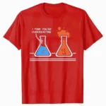 Red T-shirt featuring cartoon beakers with funny expressions and the phrase "I think you're overreacting" for science enthusiasts and humor lovers.
