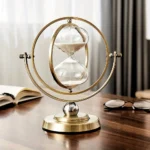 Elegant hourglass with a modern design, featuring a gold-colored frame and glass sand timer, perfect for science-themed decor and educational purposes.