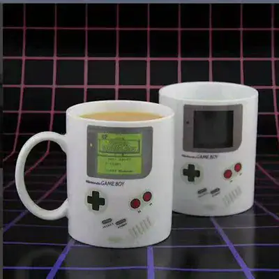 White ceramic mug designed to look like a classic Game Boy, featuring an LCD screen and control buttons, perfect for gaming enthusiasts and nostalgic collectors.