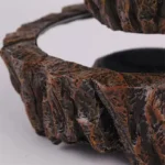 Close-up of a volcanic rock formation model showcasing detailed textures and colors, used for educational science displays and decor.