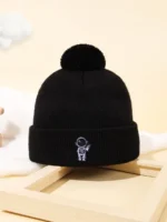 Beanie hat with astronaut embroidery and pom-pom.