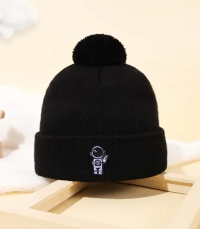 Beanie hat with astronaut embroidery and pom-pom.
