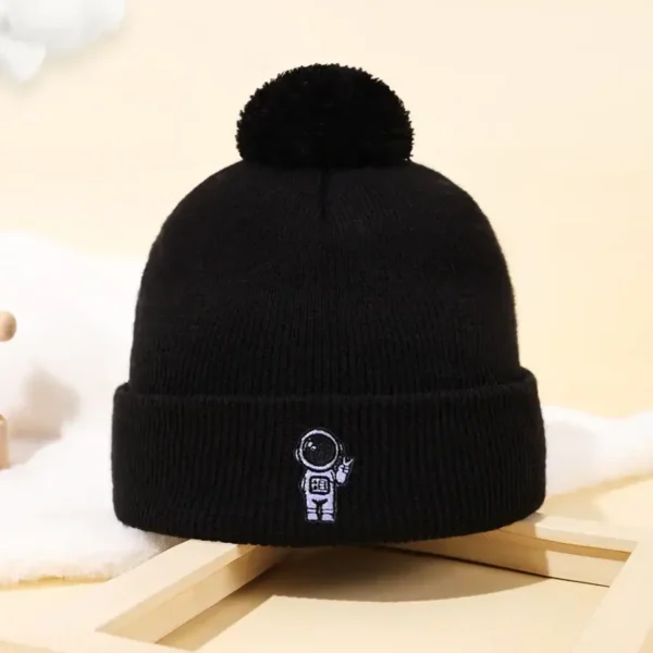 Beanie hat with astronaut embroidery and pom-pom.