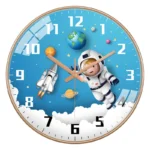 Space-themed wall clock with astronaut, rocket, planets, and stars design.
